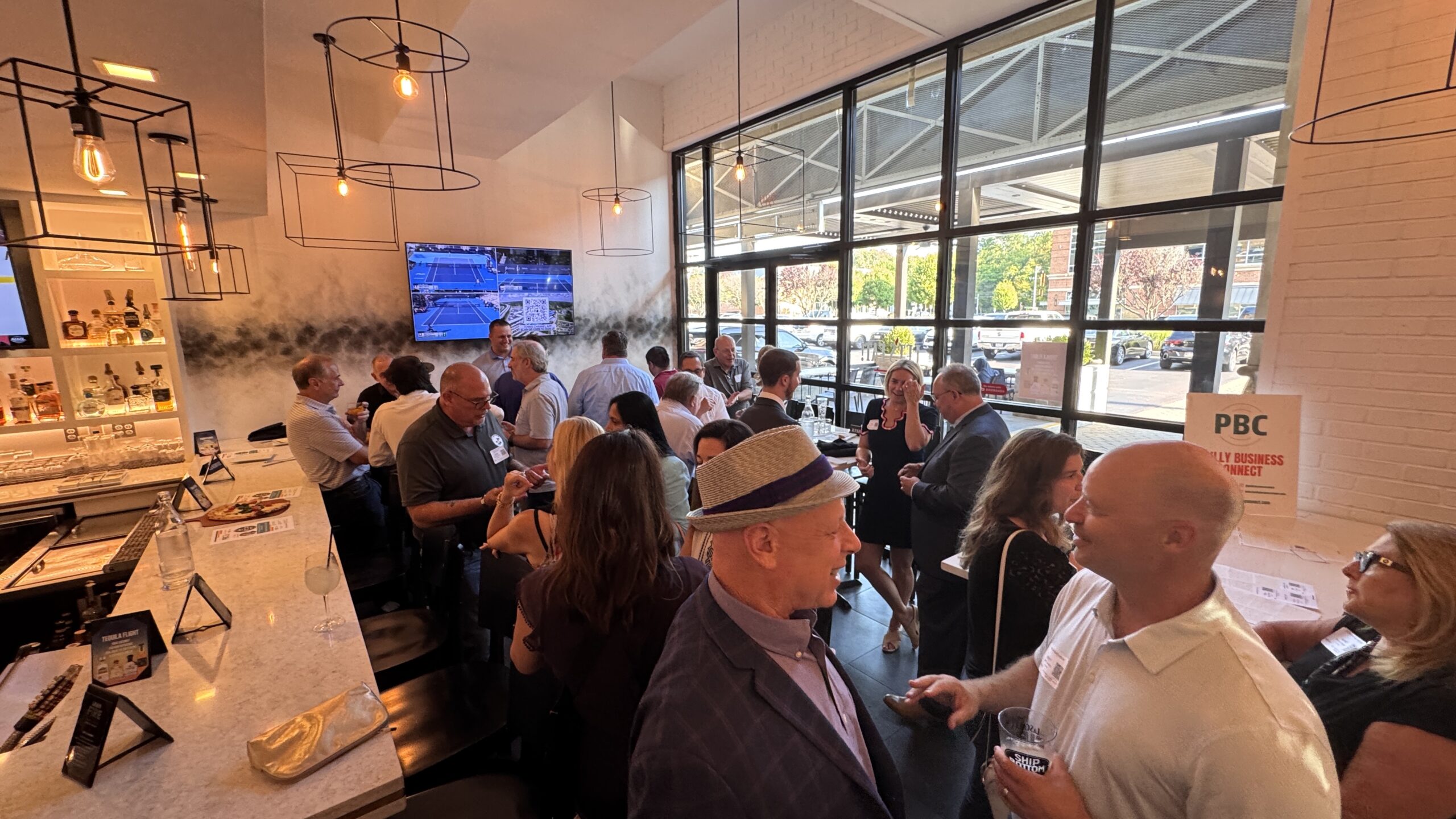 The Philly Business Connect Event at La Scala Fire. People at a classy bar area talking and networking
